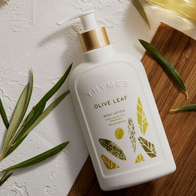 Thymes Olive Leaf Body Lotion on countertop